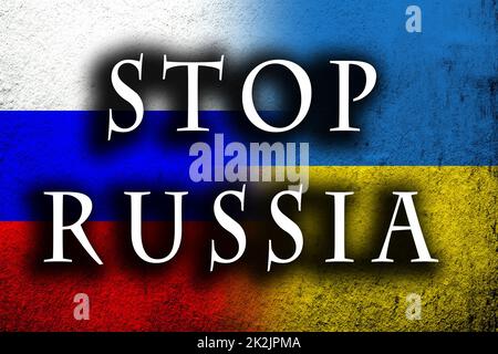 Stop Russia message on Dirty Ukraine flag with Russian flag. Grunge background Stock Photo