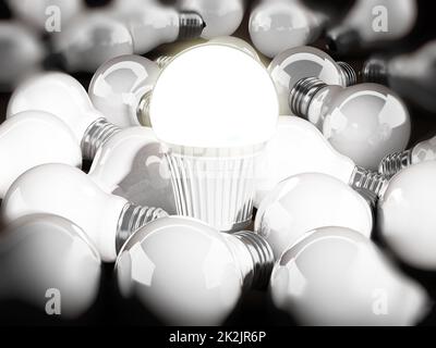 Energy efficient light bulb among standard light bulbs. 3d illustration Stock Photo