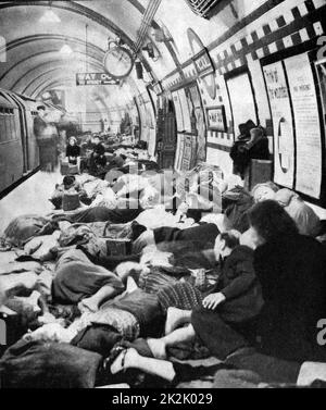 Londoners sheltering  on the platform of a station on the Tube (underground railway) during the Blitz. London was bombed on 76 consecutive nights by the Luftwaffe (German Air Force) between July 1940 and May 1941. Stock Photo