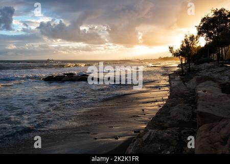 Beach during a stormy weather at sunset in Limassol. Cyprus Stock Photo