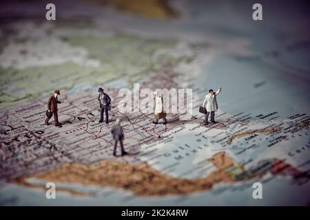 Miniature business people on top of US map. Business concept. Stock Photo