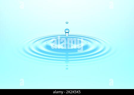 Water drop falling into water surface Stock Photo