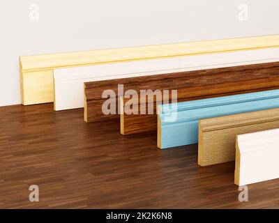 Baseboards with various profiles standing on hardwood surface. 3D ...