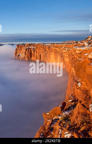 First light at sunrise on the Wingate cliffs of Junction Butte & Grandview Point with a sea of clouds below. Canyonlands NP, Utah.  A winter temperatu Stock Photo