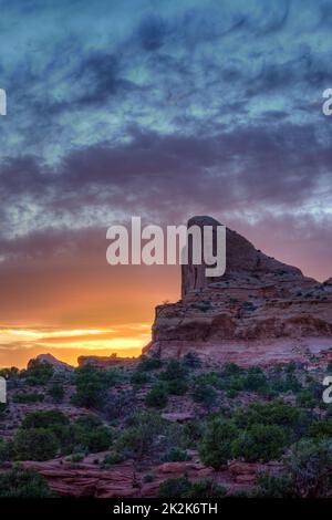 Colorful sunset clouds over the half-dome rock formation at the Green River Overlook in Canyonlands National Park, Utah. Stock Photo