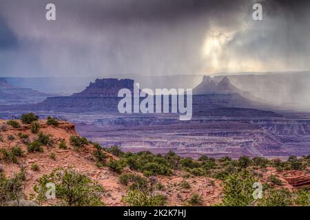 Storm clouds over Ekker Butte & the Orange Cliffs in the Glen Canyon NRA, viewed from the Candlestick Tower Overlook, Canyonlands NP, Utah. Stock Photo