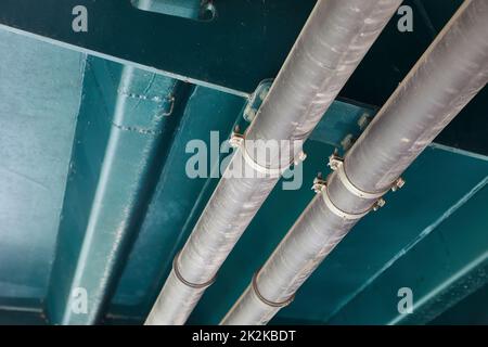 Pipelines below metal structure, urility tubes Stock Photo