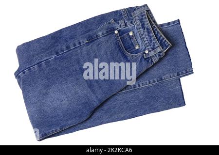 Woman jeans isolated. Folded trendy stylish female blue jeans trousers isolated on a white background. Fashionable denim pants for women. Stock Photo