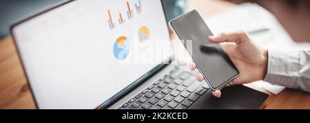 Businessman sitting at the table and using smartphone. Stock Photo