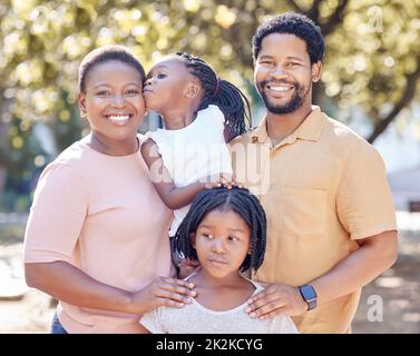 Black family, outdoor fun and smile of parents bonding and spending free time with their children on a sunny day. Portrait of happy man and woman Stock Photo
