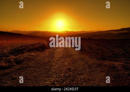 Sicily landscape with dirt road at the sunset, Italy Stock Photo