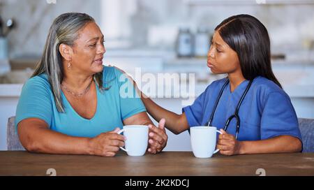 Black woman, nurse or elderly patient support, talking or comfort. Medical consultant, caregiver or female doctor having conversation with elderly Stock Photo