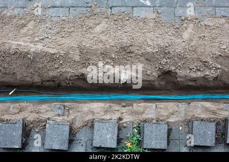 Fiber optic cables for fast internet connection laying in a trench in the Netherlands Stock Photo