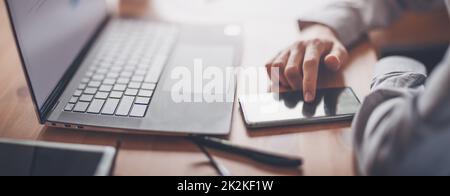 Businessman sitting at the table and using smartphone. Stock Photo