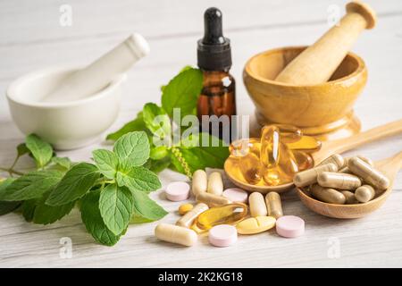 Alternative medicine herbal organic capsule drug with herbs leaf natural supplements for healthy good life. Stock Photo