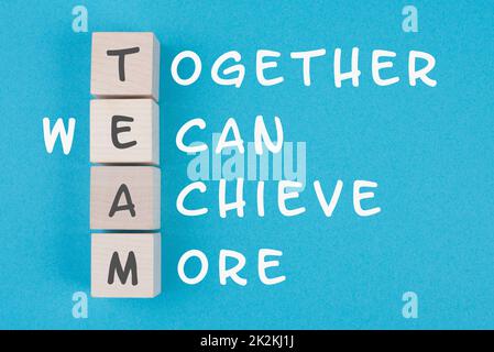 Team, together we can achieve more is standing on wooden cubes, business concept, teamwork strategy Stock Photo