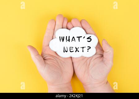 The phrase whatÂ´s next is standing on a cloud shaped paper, having new goals and strategies, making plans for future Stock Photo