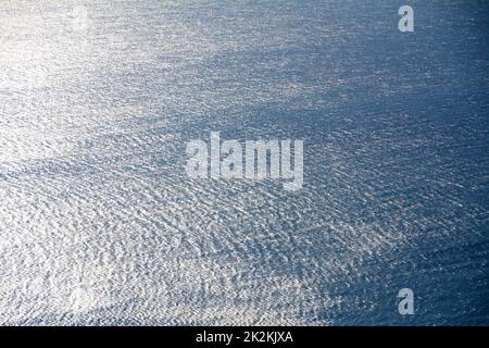 The reflections of the sea draw a fabric made of infinite reflections on the rippling of the waves. Stock Photo