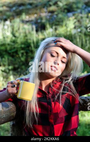 Young woman enjoying the warm sunshine outdoors Stock Photo