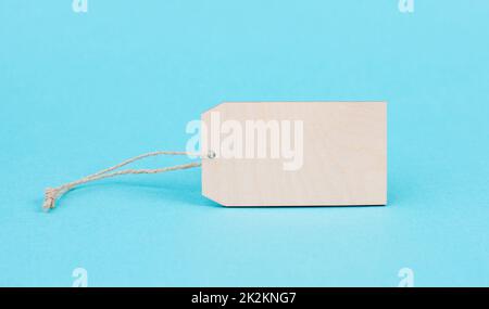 Empty price tag on a blue colored background, advertising for discount, black friday sale, blank label Stock Photo