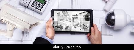 Person Watching Footage On Digital Tablet Stock Photo