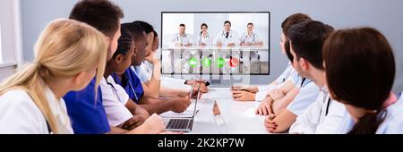 Professional Team Of Multi-ethnic Medical Doctors Having A Video Conference Stock Photo