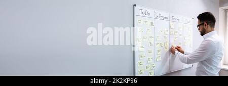 Businessman Writing On Sticky Notes Stock Photo