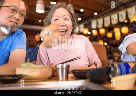 Happy mother and son having dinner and celebrating mothers day at restaurant Stock Photo
