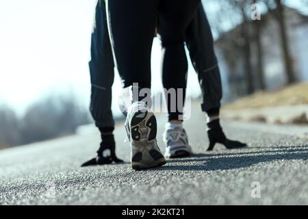 athlete simulating starting blocks on the street Stock Photo
