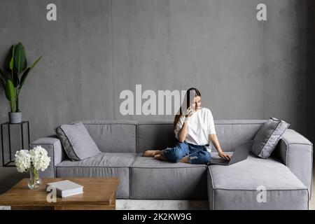 Profile side photo of woman talk phone listen use laptop stay home Stock Photo
