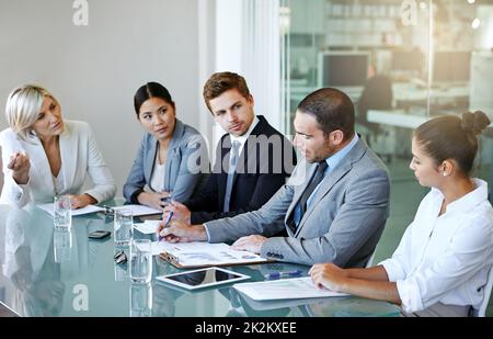 Business gets done in the boardroom. a group of businesspeople meeting in the boardroom. Stock Photo