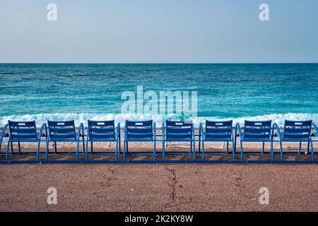 Famous blue chairs on beach of Nice, France Stock Photo