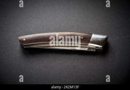 Traditional wooden pocket knife on black background Stock Photo