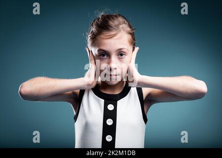 girl preventing herself to hear Stock Photo