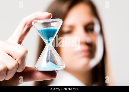 hourglass held by a concerned woman Stock Photo