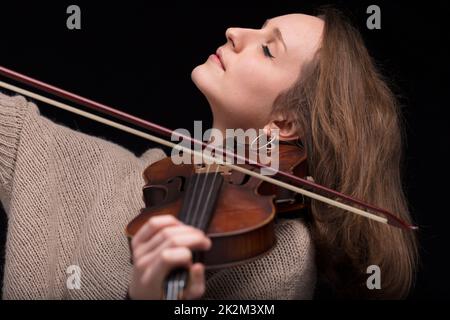 violinist woman playing with closed eyes Stock Photo