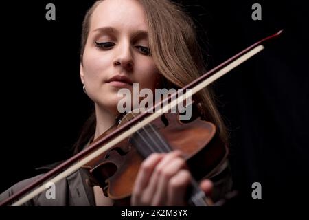 passionate violin musician playing on black background Stock Photo