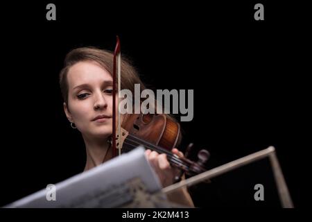 violinist reading music score and playing Stock Photo