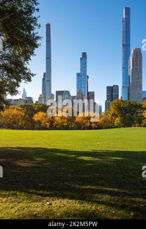 Midtown Manhattan view of Central Park in Fall with Billionaires' Row skyscrapers from Sheep Meadow. New York City Stock Photo