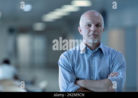 Successful confident man staring thoughtfully at the camera Stock Photo