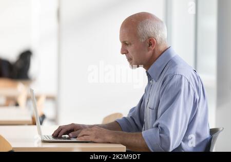 Senior businessman engrossed in his work Stock Photo