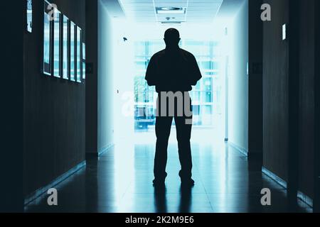 full-length portrait of a man standing in the hallway inside a new building Stock Photo