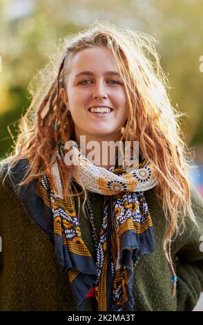 My hair is a form of self expression. Portrait of a young woman with dreadlocks posing outdoors. Stock Photo