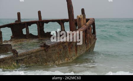 View of a rusty shipwreck in HaBonim Beach in stormy day.  Habonim shore, Israel Stock Photo