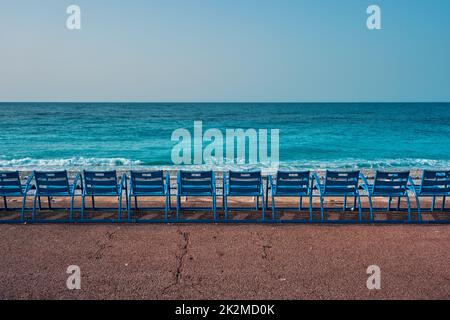 Famous blue chairs on beach of Nice, France Stock Photo