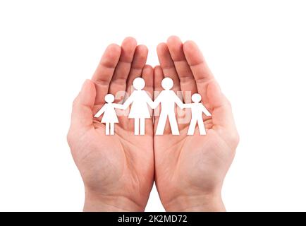 Family insurance concept with paper family cutout in hands isolated on white background with clipping path Stock Photo