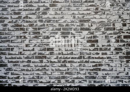 Background from a grey brick wall with a lot of cement on the surface Stock Photo