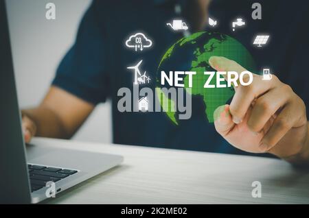 Man hand virtual world icon. NET ZERO icons and symbols save the eco world and reduce pollution virtual screen. Business eco concept. Stock Photo
