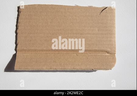 A torn piece of kraft cardboard on a white background. Template, place for text Stock Photo