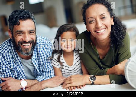 The best moments are shared as a family. Portrait of a happy family bonding together at home. Stock Photo
